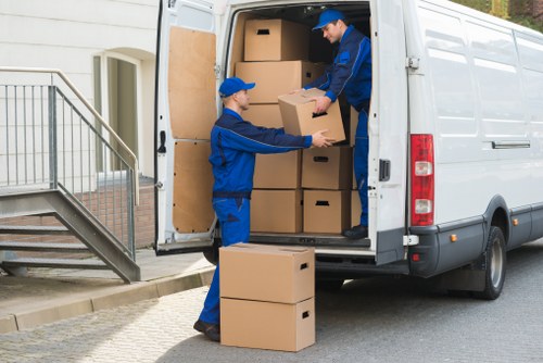 Workers using safe access and handling methods indoors