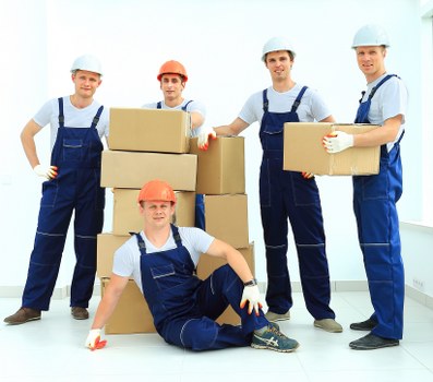 Professional movers loading boxes into a removal van in Westbrompton