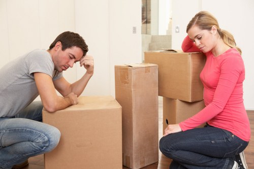 Professional movers loading furniture into a Westbrompton moving truck